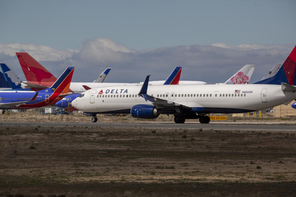 VICTORVILLE, CA - MARCH 24: A Delta Air Lines jet taxis to be parked with a growing number of jets at Southern California Logistics Airport (SCLA) on March 24, 2020 in Victorville, California. As the coronavirus pandemic grows, exponentially increasing travel restrictions and the numbers of people in quarantine, airlines around the world are scrambling to find places to park a majority of their fleet as they wait to see how the situation will play out. (Photo by David McNew/Getty Images)