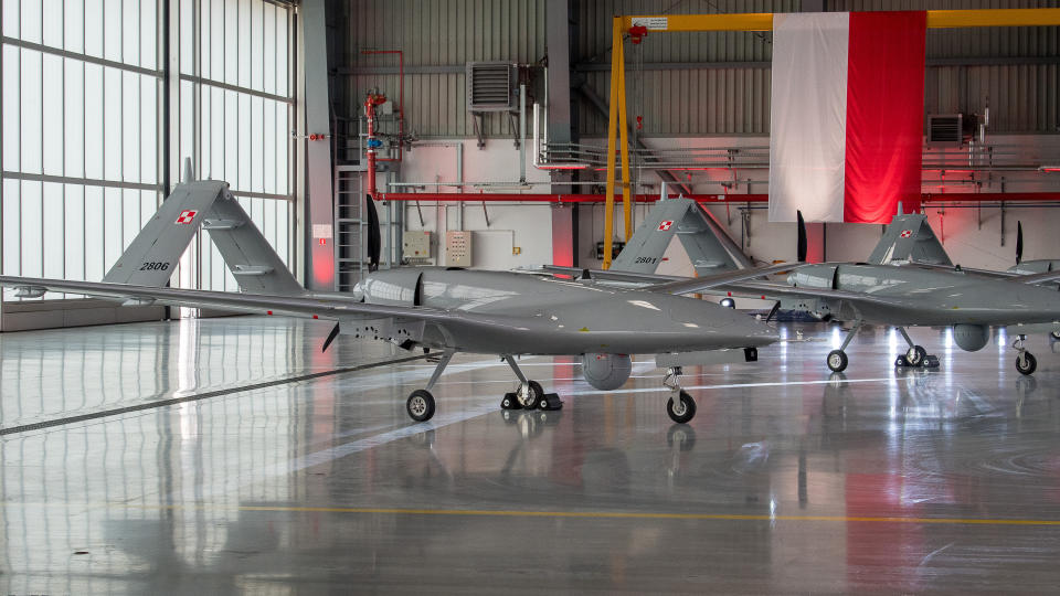 Two Turkish-made Bayraktar drones inside an aircraft hangar.