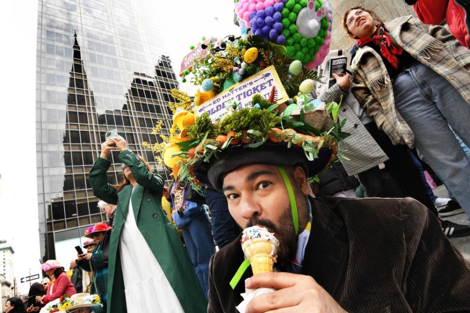 A man eats an ice cream while wearing his fun hat. Matthew McDermott
