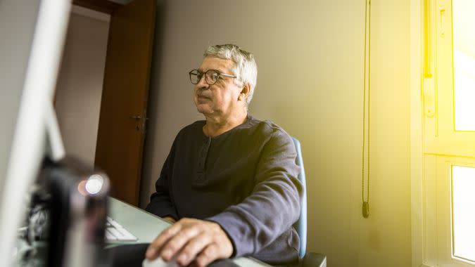 Senior man looking at computer monitor