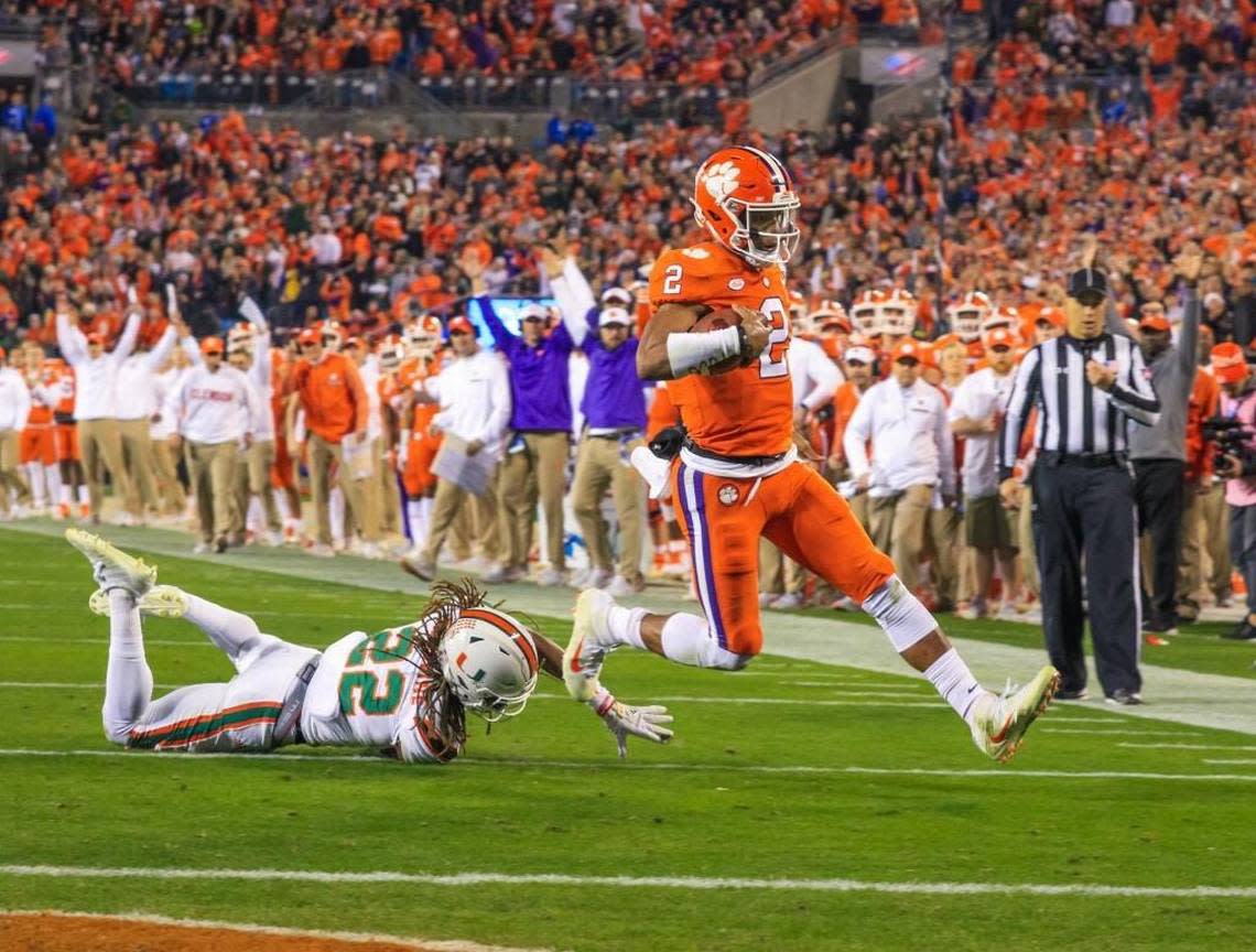 Clemson Tigers quarterback Kelly Bryant slips past diving Miami defensive back Sheldrick Redwine to score a touchdown in Saturday’s ACC Championship Game in Charlotte. Clemson won 38-3.