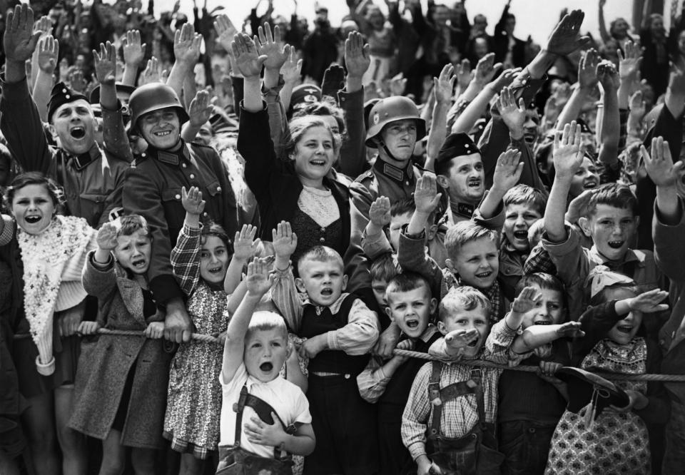 A crowd of German women, children and soldiers give the Nazi salute on June 19, 1940. (Photo: AP)