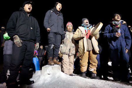 Opponents of the Dakota Access oil pipeline sing during a confrontation with police on Backwater Bridge near Cannon Ball, North Dakota, U.S., January 19, 2017. REUTERS/Terray Sylvester