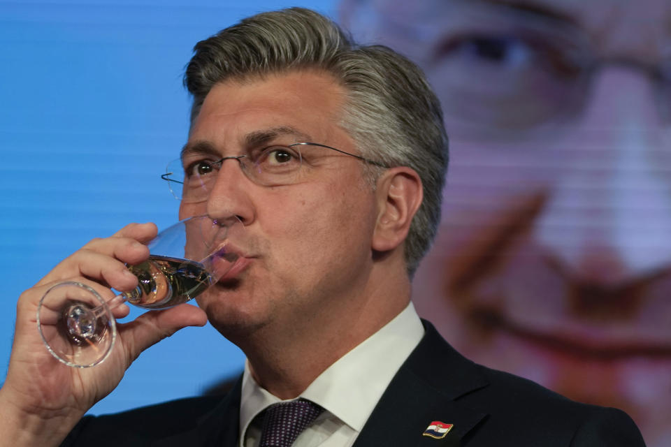 Prime Minister incumbent Andrej Plenkovic toasts with a glass of champagne after claiming victory in a parliamentary election in Zagreb, Croatia, Thursday, April 18, 2024. Croatia's governing conservatives convincingly won a highly contested parliamentary election Wednesday, but will still need support from far-right groups to stay in power, according to the official vote count. The election followed a campaign that centered on a bitter rivalry between the country's president and prime minister. (AP Photo/Darko Vojinovic)