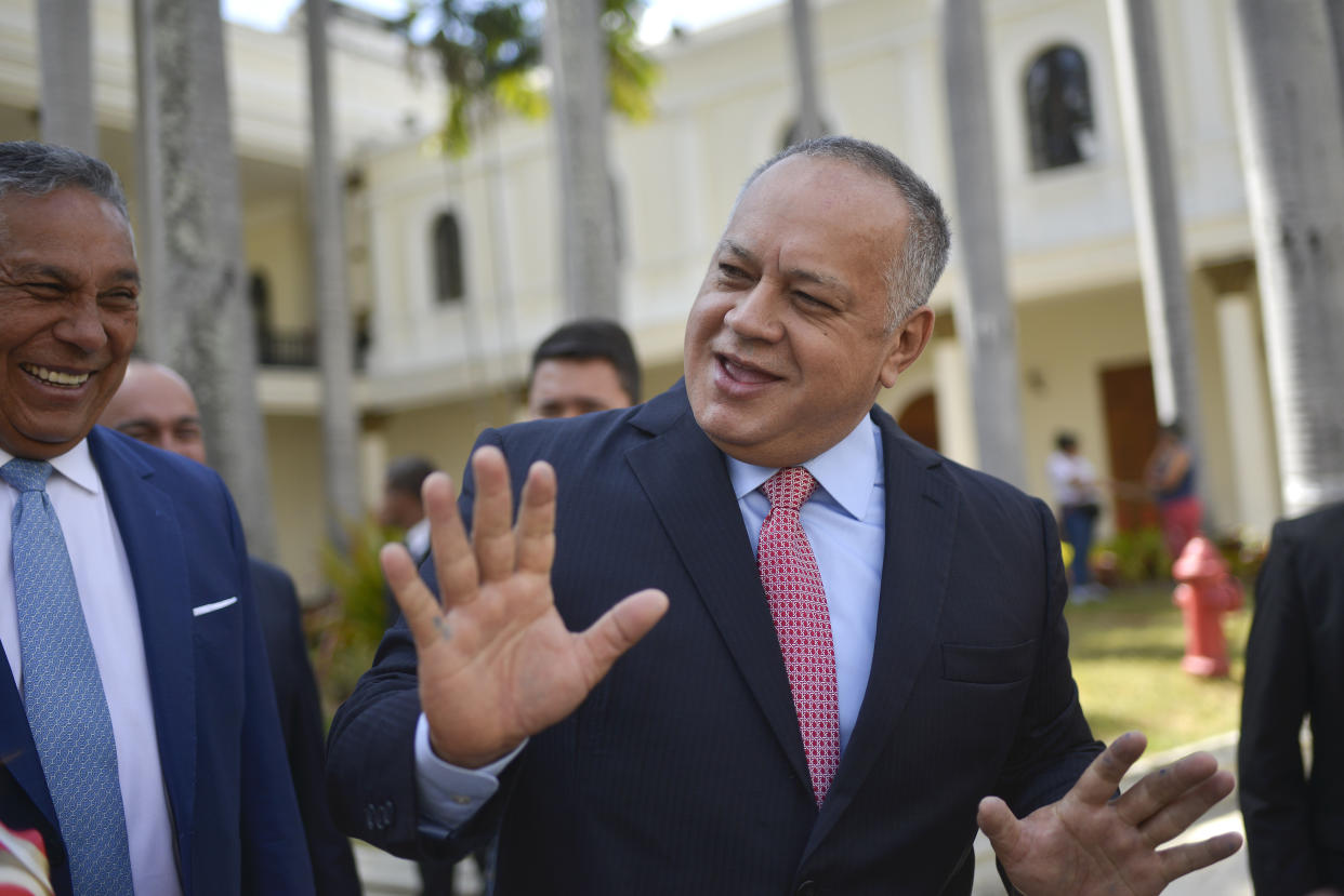 Diosdado Cabello, president of the National Constituent Assembly, jokes with lawmakers after giving a press conference at the National Assembly in Caracas, Venezuela, Wednesday, Jan. 8, 2020. A fight for control of the legislature comes as the opposition is struggling to regain its momentum, nearly a year after opposition leader Juan Guaido declared himself interim president of the nation. (AP Photo/Matias Delacroix)