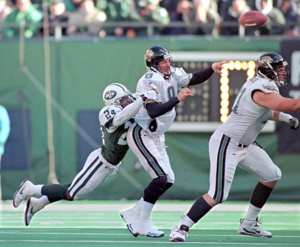 New York Jets cornerback Ray Mickens (24) hits Jacksonville Jaguars quarterback Mark Brunell (8) as he attempts to pass during the AFC divisional playoff at Giants Stadium on Jan. 10, 1999. [Rick Wilson/Florida Times-Union]