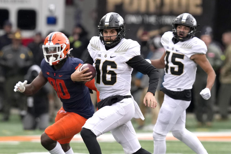 Purdue quarterback Aidan O'Connell carries the ball during the first half of an NCAA college football game against Illinois Saturday, Nov. 12, 2022, in Champaign, Ill. (AP Photo/Charles Rex Arbogast)