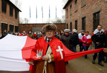 Far right activists pay tribute to Polish victims at the "death wall" in the former Nazi German concentration and extermination camp Auschwitz, during the ceremonies marking the 74th anniversary of the liberation of the camp and International Holocaust Victims Remembrance Day, in Oswiecim, Poland, January 27, 2019. REUTERS/Kacper Pempel