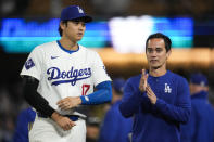 Los Angeles Dodgers designated hitter Shohei Ohtani (17) walks with his interpreter, Will Ireton, after a baseball game against the Atlanta Braves in Los Angeles, Saturday, May 4, 2024. (AP Photo/Ashley Landis)