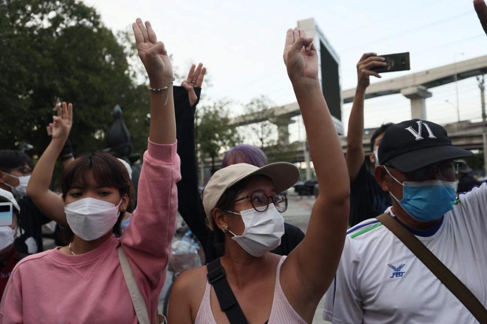 Protesters hold up the three finger salute outside the Constitutional Court of Thailand in Bangkok (AFP via Getty Images)