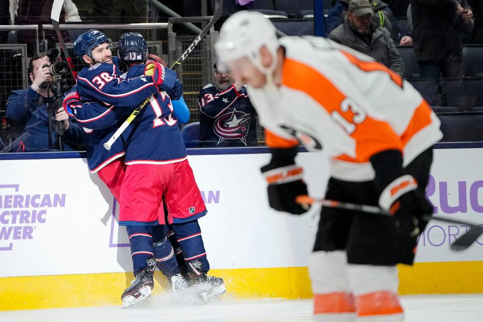 Nov 15, 2022; Columbus, Ohio, USA;  Columbus Blue Jackets center Boone Jenner (38) celebrates his second goal of the game with left wing Johnny Gaudreau (13) during the third period of the NHL hockey game against the Philadelphia Flyers at Nationwide Arena. The Blue Jackets won 5-4. Mandatory Credit: Adam Cairns-The Columbus Dispatch