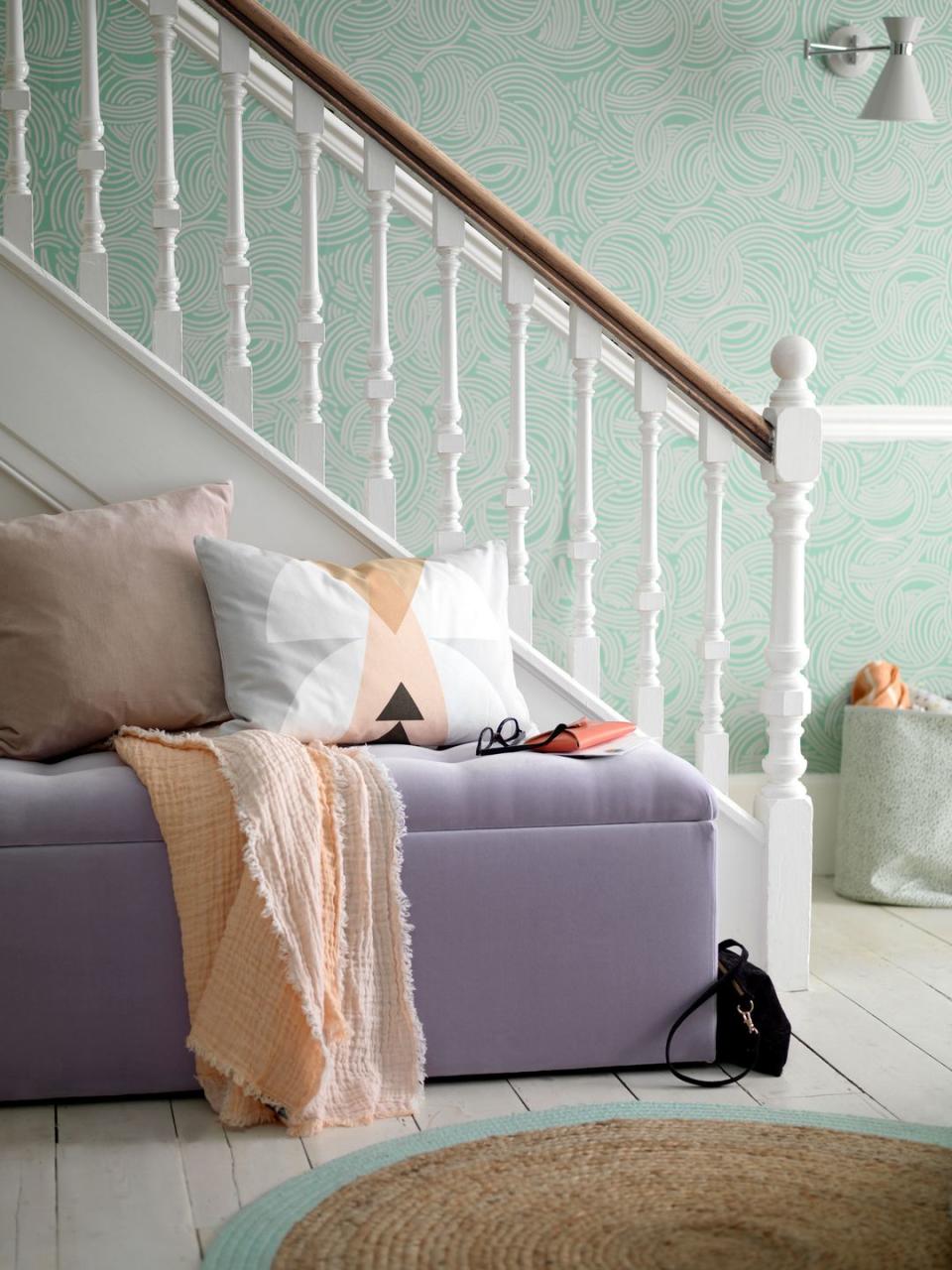 a wonderfully tactile and stylishly useful velvet ottoman adds glamour to the hallway