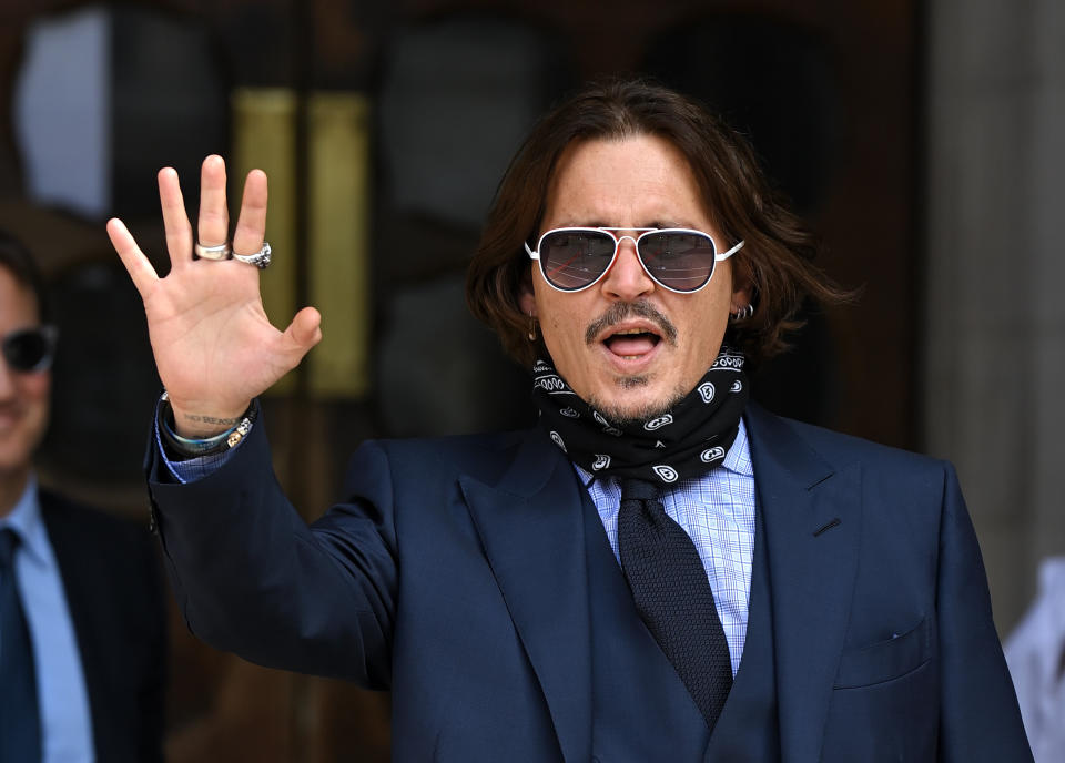 Johnny Depp waves to crowds on day 6 of his libel case against The Sun Newspaper at the Royal Courts of Justice, Strand on July 14, 2020 in London, England. American actor Johnny Depp is taking News Group Newspapers, publishers of The Sun, to court over allegations that he was violent towards his ex-wife, Amber Heard, 34