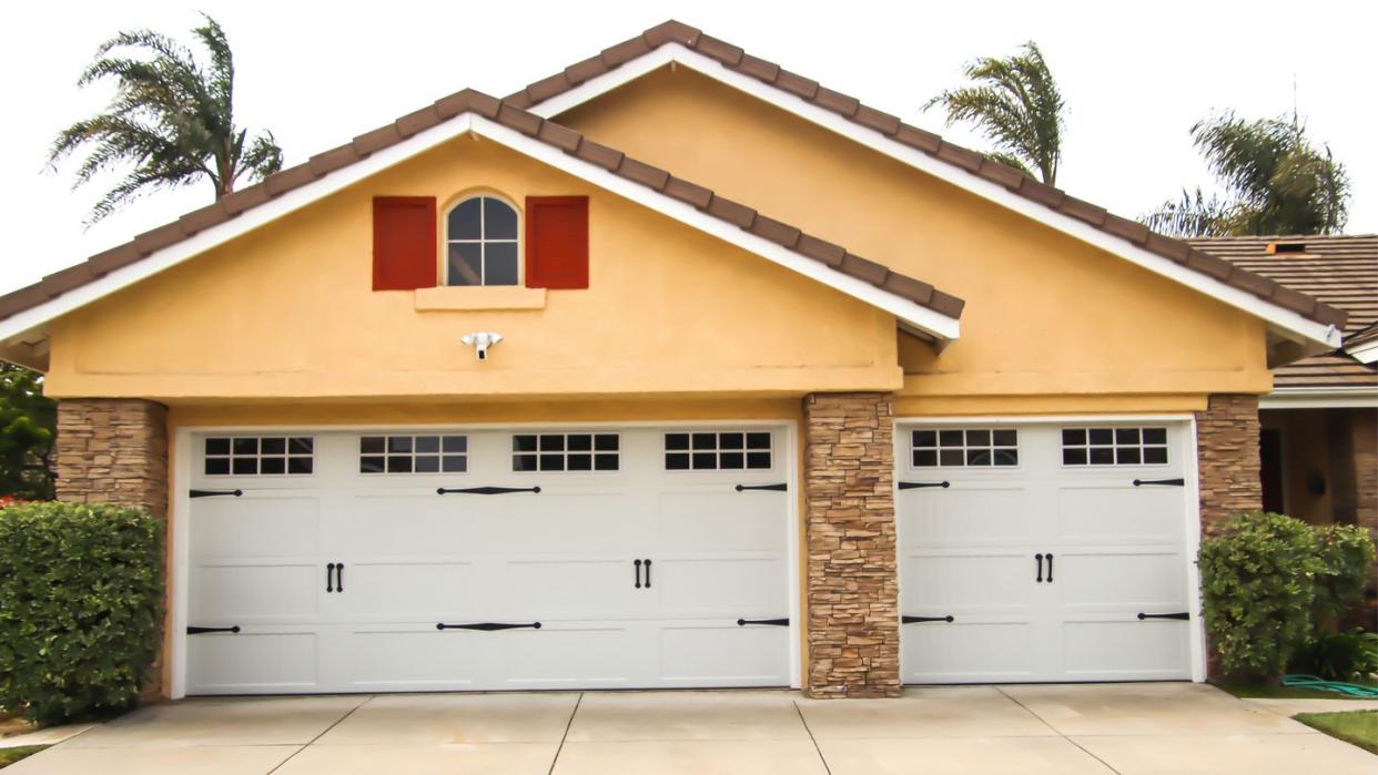 home exterior with carriage style garage doors