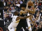 Jan 11, 2019; Toronto, Ontario, CAN; Brooklyn Nets center Jarrett Allen (31) keeps the ball away from Toronto Raptors forward Serge Ibaka (9) at Scotiabank Arena. Mandatory Credit: John E. Sokolowski-USA TODAY Sports