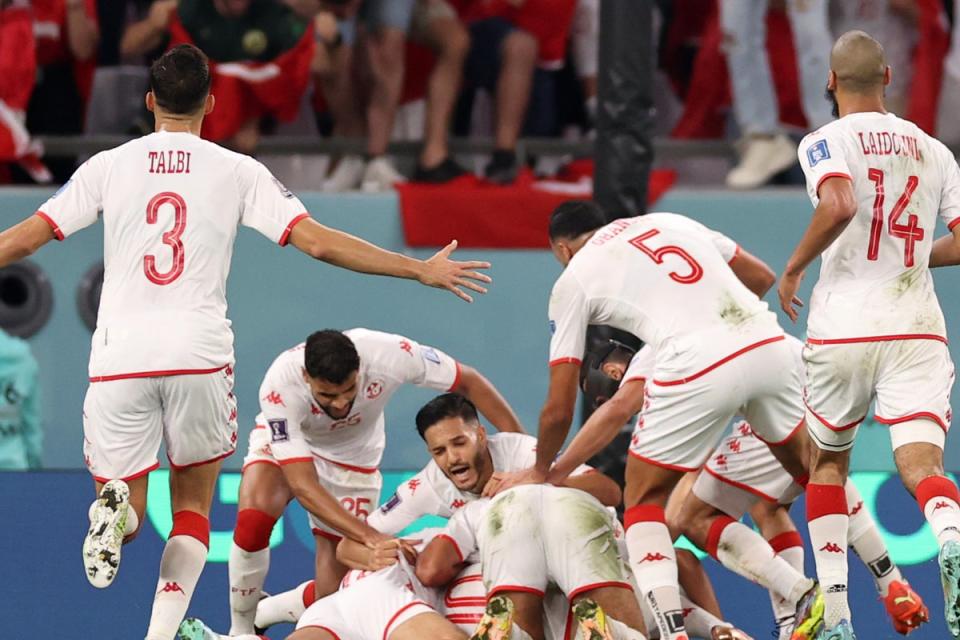 Celebration: Tunisia’s players mob Wahbi Khazri after his goal that downed France  (Getty Images)