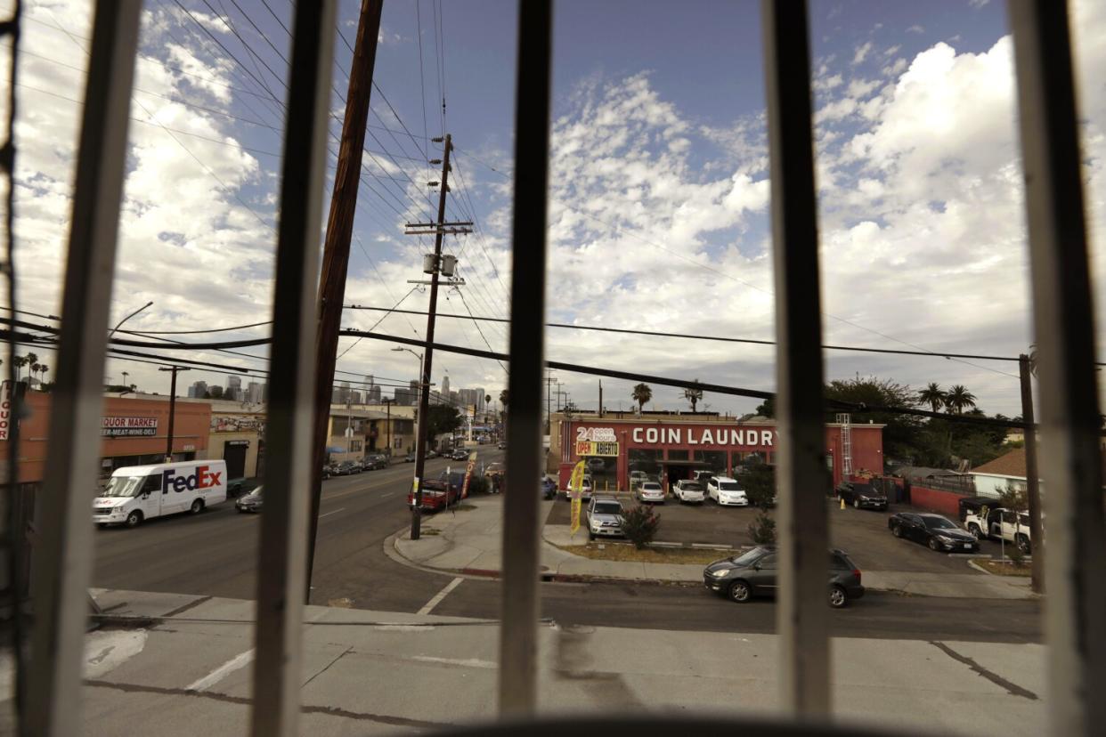 A view of a street and businesses from inside a home's window