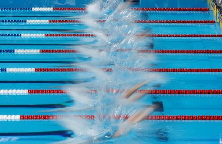 Swimmers dive in the pool to start their men's 100m freestyle heat during the U.S. Olympic swimming trials in Omaha, Nebraska, June 28, 2012. REUTERS/Jeff Haynes