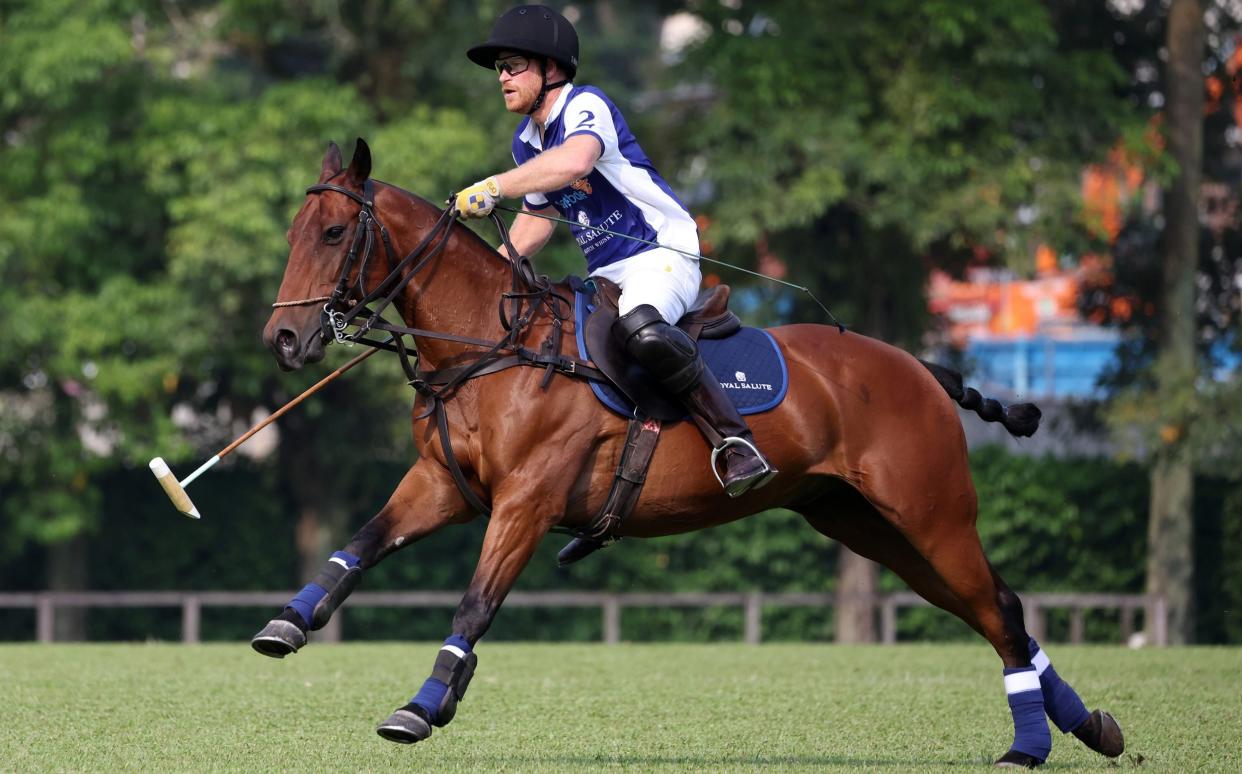 Prince Harry plays polo on the Royal Salute Sentebale Team against the Singapore Polo Club Team