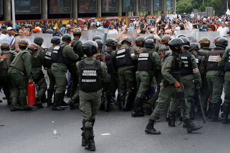 Venezuelan National Guards clash with opposition supporters during a rally to demand a referendum to remove President Nicolas Maduro in Caracas, Venezuela, May 11, 2016. REUTERS/Carlos Garcia Rawlins