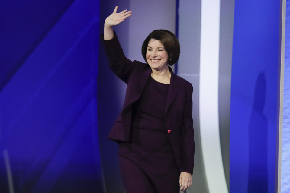 Sen. Amy Klobuchar, D-Minn., waves on stage Friday, Feb. 7, 2020, before the start of a Democratic presidential primary debate hosted by ABC News, Apple News, and WMUR-TV at Saint Anselm College in Manchester, N.H. (AP Photo/Charles Krupa)