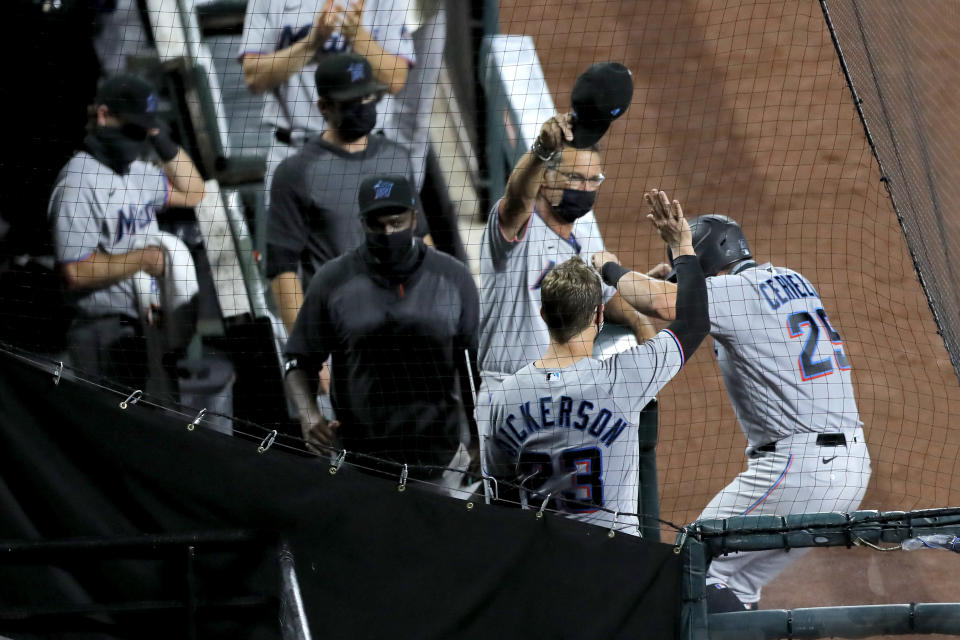 Miami Marlins' Francisco Cervelli, right, reacts while celebrating near his team's dugout after hitting a solo home run off Baltimore Orioles starting pitcher John Means during the fifth inning of a baseball game, Tuesday, Aug. 4, 2020, in Baltimore. (AP Photo/Julio Cortez)