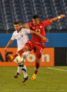 NASHVILLE, TN - MARCH 24: Lucas Cavallini #13 of Canada and Perry Kitchen #4 of the USA jump for a ball in a 2012 CONCACAF Men's Olympic Qualifying match at LP Field on March 24, 2012 in Nashville, Tennessee. (Photo by Frederick Breedon/Getty Images)