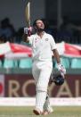 India's Cheteshwar Pujara celebrates his century during the second day of their third and final test cricket match against Sri Lanka in Colombo , August 29, 2015. REUTERS/Dinuka Liyanawatte