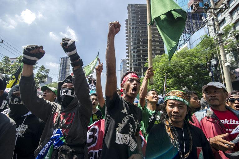 Football fans shout slogans during a rally outside the venue hosting the Indonesian Football Association extra-ordinary congress in Surabaya, Java on April 18, 2015