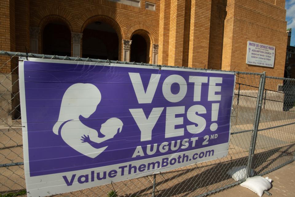 A large sign in support of the Value Them Both bill is seen in front of the Assumption Church across from the Kansas Statehouse. Kansas voters rejected amending the constitution to criminalize abortion.