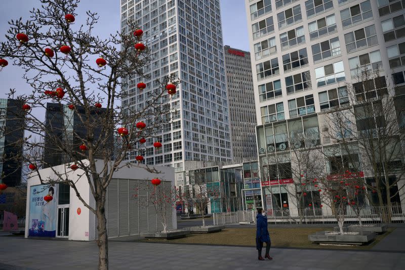 Woman wearing a face mask walks in Beijing's central business district