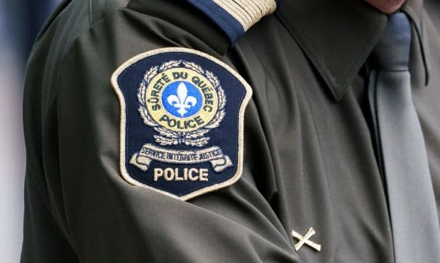 Sûreté du Québec police brought in a canine team to double check the area for explosives after three bombs were found in an apartment. (Paul Chiasson/The Canadian Press - image credit)