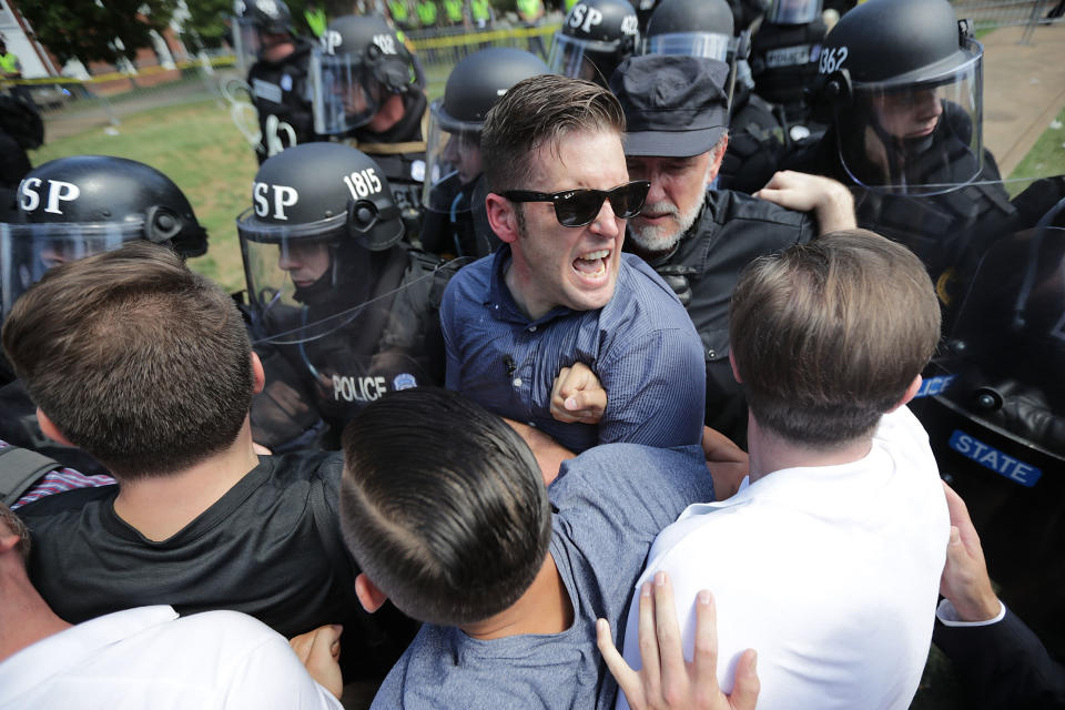 Spencer (in glasses) jammed against a line of riot cops during a white supremacist rally in Charlottesville, Virginia, on Aug. 12, 2017. (Photo: Chip Somodevilla via Getty Images)