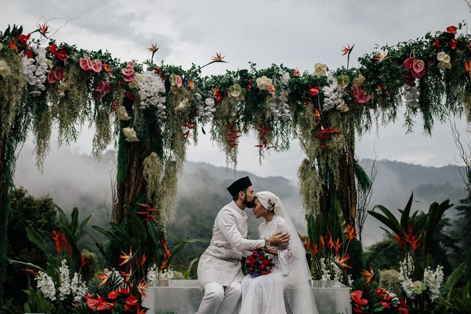 <p>Whether you're in your backyard or wedding in a remote, far away destination—like the Malaysian jungle pictured here—look to the natural elements of your surroundings when designing your ceremony's focal point. The floral design of this ceremony may be lush and dramatic, but the tropical blooms were sourced locally, using the flora and fauna of the wedding location as a guide. Other than the blooming altar, this couple kept it simple—and let the landscape speak for itself.</p><p><em>Pictured: <a href="https://www.harpersbazaar.com/wedding/photos/a28092024/yuna-zarai-adam-sinclair-wedding-malaysia/" rel="nofollow noopener" target="_blank" data-ylk="slk:Yuna and Adam's wedding in Malaysia;elm:context_link;itc:0;sec:content-canvas" class="link ">Yuna and Adam's wedding in Malaysia</a>; Planning and design by <a href="https://www.instagram.com/the_calla/?hl=en" rel="nofollow noopener" target="_blank" data-ylk="slk:The Calla;elm:context_link;itc:0;sec:content-canvas" class="link ">The Calla</a> and <a href="https://ysaevents.com/" rel="nofollow noopener" target="_blank" data-ylk="slk:YSA Events;elm:context_link;itc:0;sec:content-canvas" class="link ">YSA Events</a>; Florals by <a href="https://www.instagram.com/flores.kl/?hl=en" rel="nofollow noopener" target="_blank" data-ylk="slk:FLORES KL;elm:context_link;itc:0;sec:content-canvas" class="link ">FLORES KL</a>.</em></p>