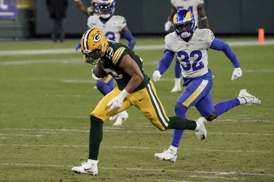 Green Bay Packers' Allen Lazard breaks away from Los Angeles Rams' Jordan Fuller (32) to score on a 58-yard touchdown run during the second half of an NFL divisional playoff football game Saturday, Jan. 16, 2021, in Green Bay, Wis. (AP Photo/Morry Gash)