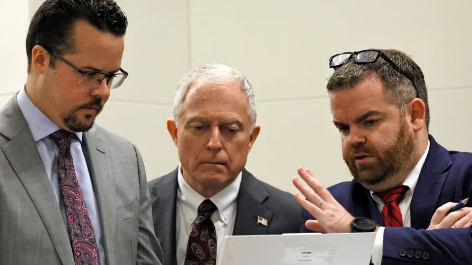 From left, legal assistant Aaron Savitski and Assistant State Attorneys Steven Klinger and Christopher Killoran view video played in court during Peterson's trial on Wednesday, June 21, 2023.  - Amy Beth Bennett/South Florida Sun-Sentinel/AP