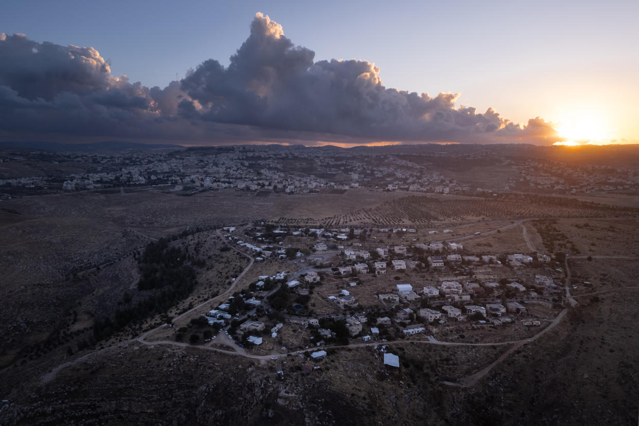 An aerial view of the Israeli settlement of Tekoa and, in the background, the Palestinian town of Tuqu in the occupied West Bank, Tuesday, May 7, 2024. (Sergey Ponomarev/The New York Times)