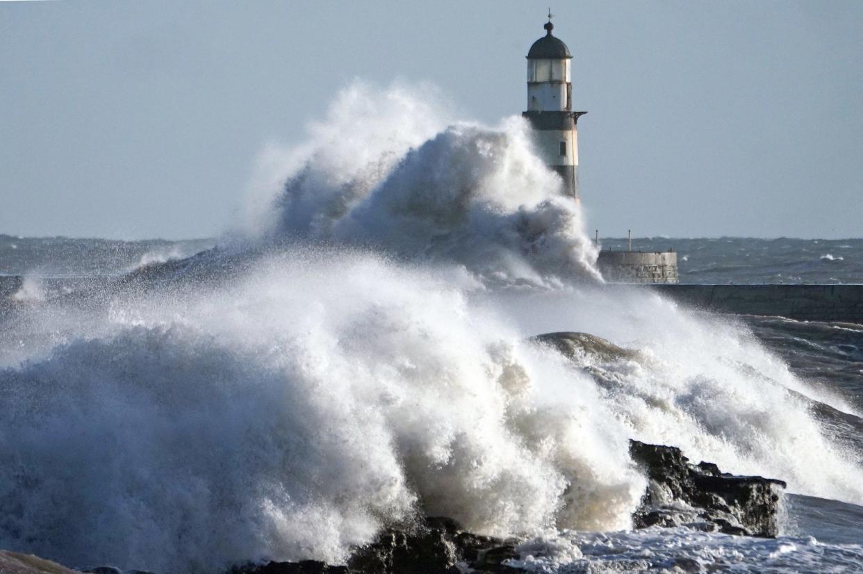 Waves crash against the pier wall at Seaham Lighthouse on the County Durham coast on Monday: PA