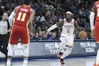 Oklahoma City Thunder forward Luguentz Dort (5) looks for an opening past Atlanta Hawks guard Trae Young (11) in the second half of an NBA basketball game, Wednesday, Jan. 25, 2023, in Oklahoma City. (AP Photo/Kyle Phillips)