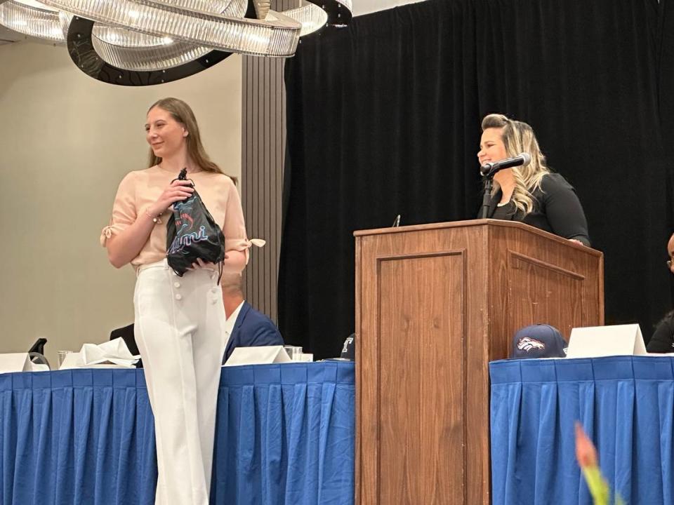 Miami Killian softball player Tori Allen (left) is presented with a $1,000 scholarship award by Miami Marlins Youth Foundation Senior Director Sarah Martin (right).