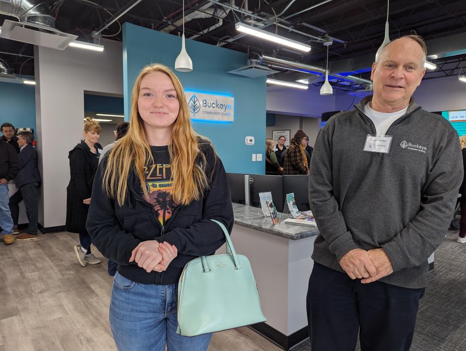 Buckeye Community School graduate Olivia Kennedy, left, stands with Vice Principal Steve Hofacker, as she fields questions during the ribbon-cutting ceremony at the new school in Fremont on Monday.