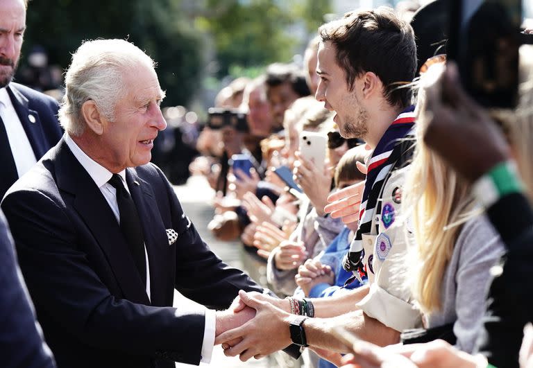 El rey Carlos III saluda a miembros del público que esperan para ingresar a Westminster Hall