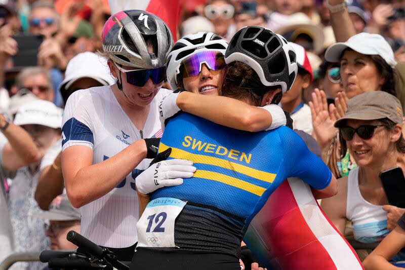 From left, Haley Batten, of United States, silver, Pauline Ferrand Prevot, of France, gold, and Jenny Rissveds, of Sweden, bronze, after completing the women's mountain bike cycling event, at the 2024 Summer Olympics, Sunday, July 28, 2024, in Elancourt, France. | George Walker IV