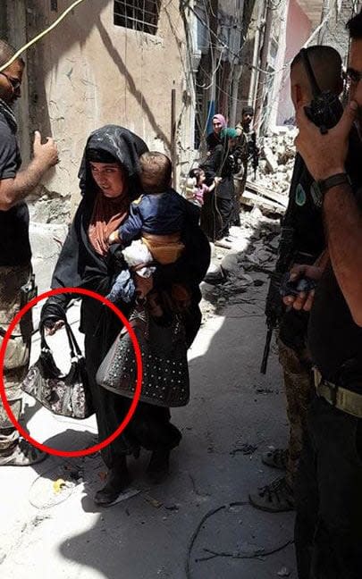 Woman said to be holding detonator in Mosul blows herself up along with a small child moments after the picture was taken.  - AL-MAWSLEYA TV