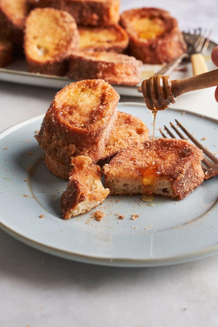 <p>Rabanadas is the Portuguese, cinnamon-sugar covered version of french toast. The bread is first dipped in a sweetened <em>warmed</em> milk and then in egg to help create a more custardy inside. </p><p>Get the <strong><a href="https://www.delish.com/cooking/recipe-ideas/a33472912/rabanadas-brazilian-portuguese-french-toast-recipe/" rel="nofollow noopener" target="_blank" data-ylk="slk:Rabanadas recipe" class="link ">Rabanadas recipe</a>. </strong></p>