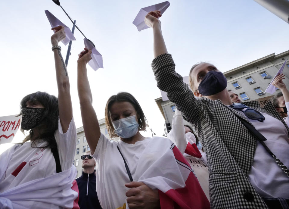 Protesters hold up paper planes during a demonstration of Belarusians living in Poland and Poles supporting them in front of European Commission office in Warsaw demanding freedom for Belarus opposition activist Raman Protasevich in Warsaw, Poland, Monday, May 24, 2021. Western outrage grew and the European Union threatened more sanctions Monday against Belarus over its forced diversion of a passenger jet to the capital of Minsk in order to arrest opposition journalist Raman Protasevich in a dramatic gambit that some said amounted to state terrorism or piracy. (AP Photo/Czarek Sokolowski)