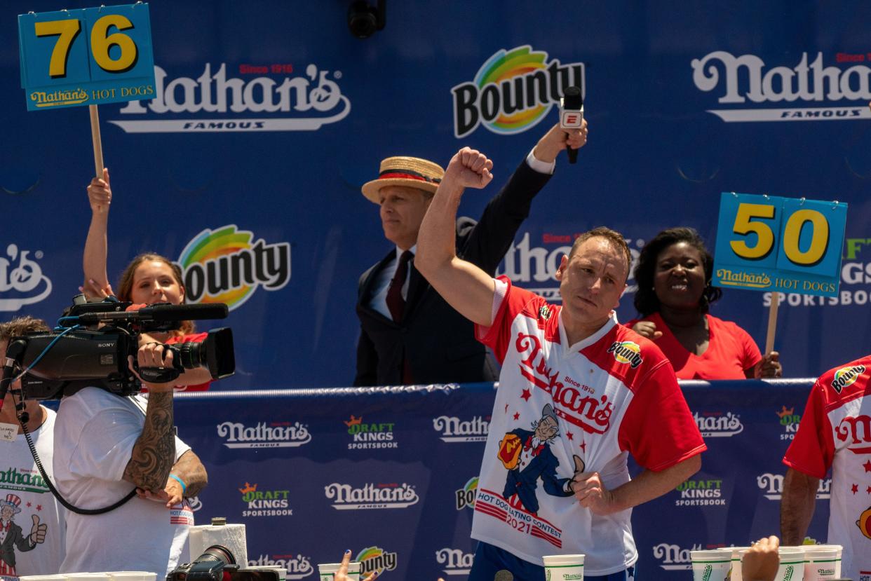 Competitive eating champion Joey "Jaws" Chestnut wins the 2021 Nathan's Famous 4th Of July International Hot Dog Eating Contest with 76 hot dogs, breaking his personal best record of 75, at Coney Island on July 4, 2021, in New York City.