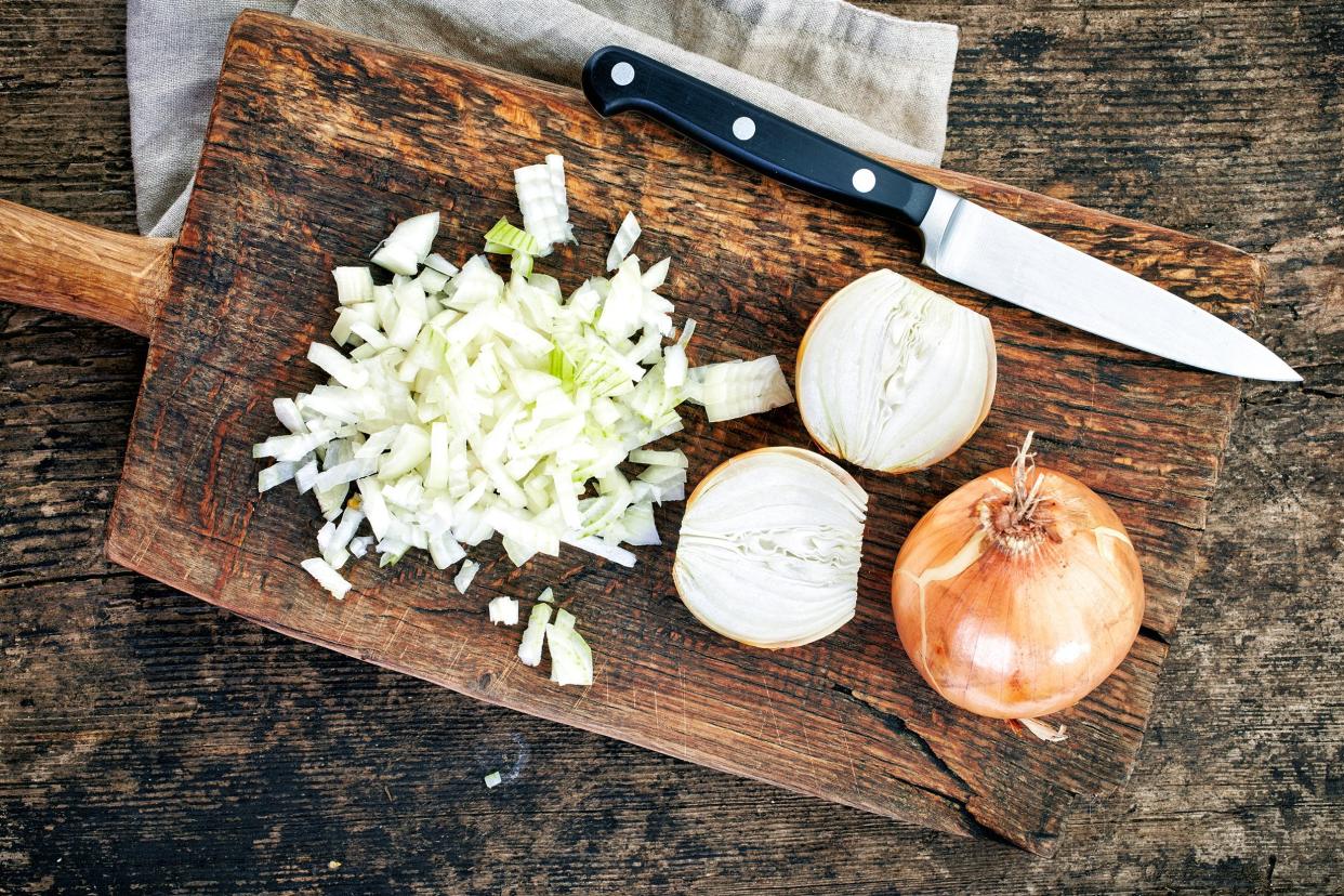 chopped onions on wooden cutting board