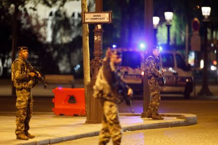 Armed soldiers secure the Champs Elysees Avenue after a shooting incident in Paris, France, April 20, 2017. REUTERS/Benoit Tessier