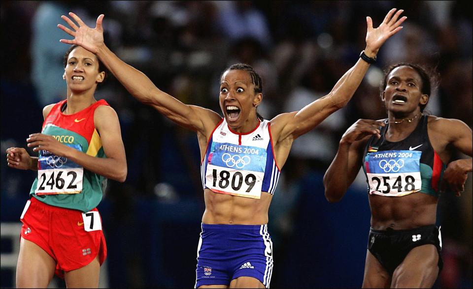 Dame Kelly Holmes, centre, celebrates her 800m win in Athens (Phil Noble/PA) (PA Archive)